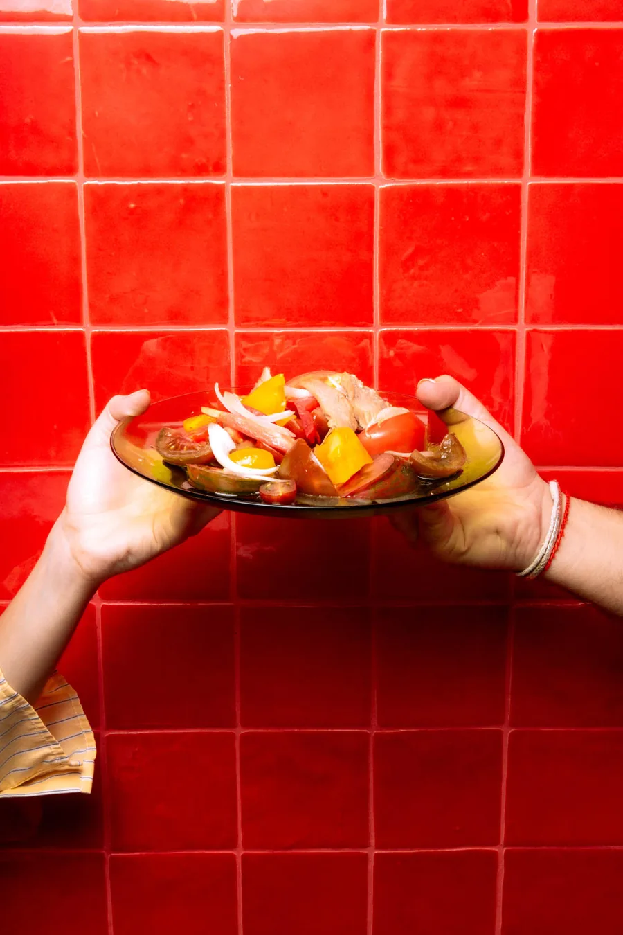 Un plato de Casa Pepi servido sobre la pared roja del local